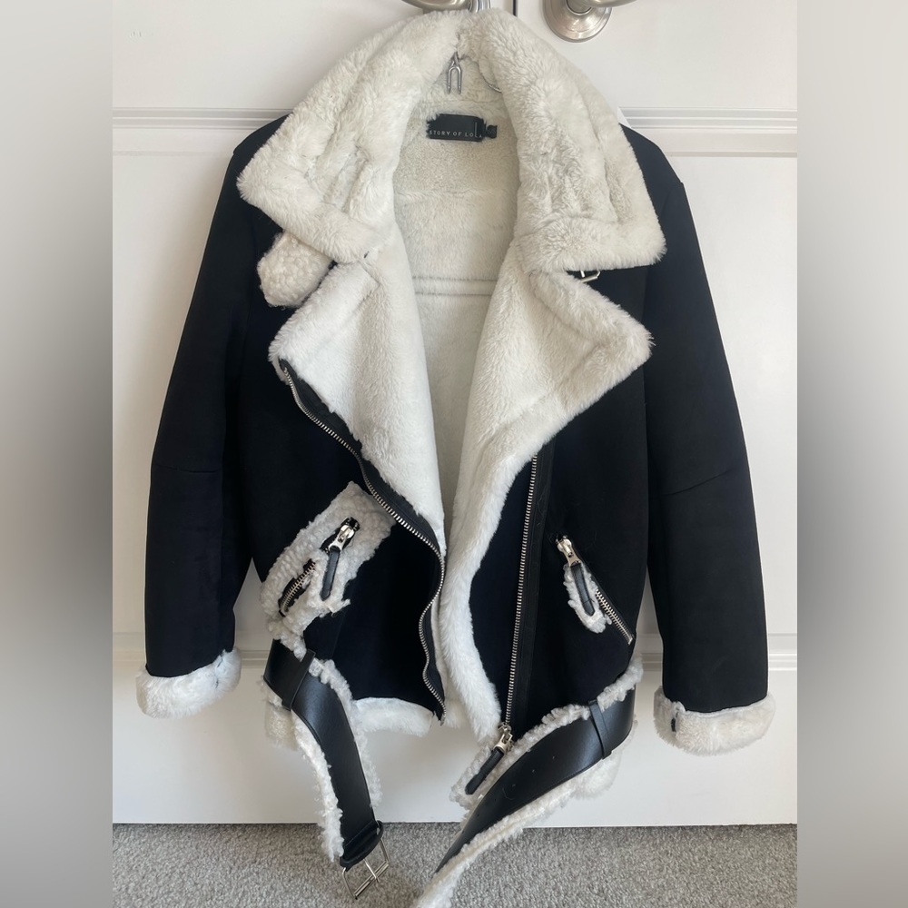 black and white fur lined coat with sherpa details